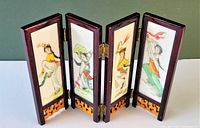Front view of the vintage 4 panel folding table screen featuring hand painted translucent resin panels portraying Asian figures.