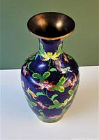 Top-down view emphasizing the interior and the flared brass or bronze rim, along with visible dent near the base