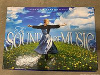 The front cover of The Sound of Music box set featuring Julie Andrews in a field with arms outstretched.