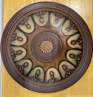 Front view of the round Mid Century German pottery wall plate showing intricate glaze and geometric floral design in warm earth tones.