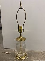 Full view of the vintage handcut lead crystal table lamp with brass fittings and harp.