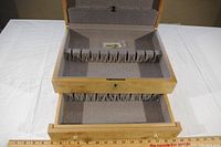 Top interior view showing felt lining with individual slots for silverware and additional storage drawer underneath.
