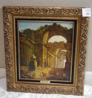 Full view of framed art print showing ornate gold-colored frame and classical architectural scene within the print.