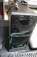 Front view of HP Pavilion desktop tower showing front media card reader, optical drive and Beats Audio logo, topped with USB webcam
