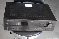 Yamaha HTR-5630 receiver showing top view with ventilation slots and some surface wear.
