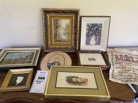 All items arranged on table showing eight artworks and sampler