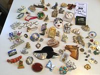 Full view of assortment of pins and brooches, showcasing variety of styles, colors, and materials.