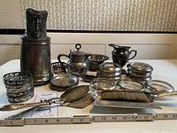 Wide view showing entire lot with pitcher, coasters, trays and serving utensils