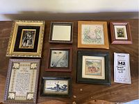 Group shot showing all eight framed accent art pieces on wood surface