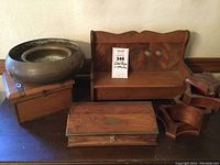Overview of lot with two metal planters, wooden boxes, small doll bench, and nested wooden trays.