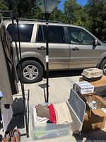 72-inch tall black floor lamp with white lacy plastic lampshade, standing outdoors next to vehicle.