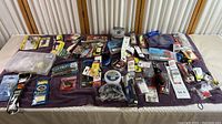 Photo overview of all fishing supplies displayed on a table showing various packages of fishing line, hooks, lures, and tools.