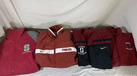 Four jackets displayed together, various Stanford Sports Medicine designs, mostly maroon and red colors.