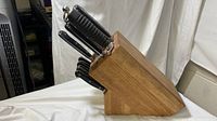Full view of wooden knife block loaded with knives and sharpener, showing condition and layout