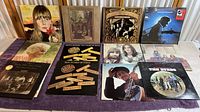 Photo showing multiple vinyl record jackets laid out on table including Joni Mitchell, Tammy Wynette, Crosby Stills Nash & Young