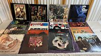 Full collection of approximately 17 vinyl records, 12 inch size, showing cover art and condition.