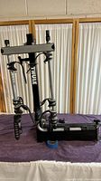 Full view of Thule 2 bike swing away hitch carrier folded and placed on fabric surface