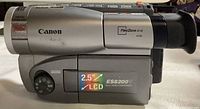 Side view of Canon ES8200V 8mm camcorder showing branding, LCD info, and some wear marks
