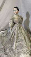 Full front view of vintage La Motte porcelain doll wearing pale blue lace dress with puffed sleeves.