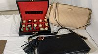 Full view of jewelry box with earrings and both purses showing their tops and straps.