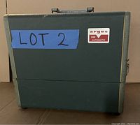 Green textured Argus carrying case with handle and LOT 2 label.