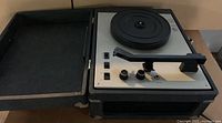 Image of open portable Califone record player showing turntable, tone arm, and control panel