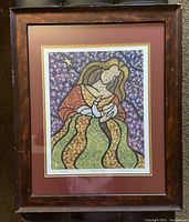 Full view of framed print "Mother and Child" showing colorful stylized mother and child figure in a dark wooden frame with matting.