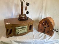 Curtis turntable, replica rotary phone, and Thomas olde tyme radio grouped on table with sheet background