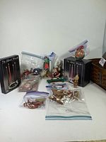 Full basket contents spread out including boxed advent candles, and various ornaments in clear zip bags