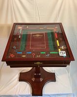 Front view of square game table showing glass-covered Monopoly board