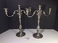Pair of Gorham candelabra displayed side by side against a black background