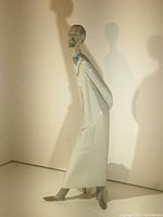 Full side profile of the Lladro doctor figurine standing 13.75 inches tall, showing the long white coat and posture.
