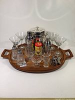 Full lot on large wooden tray showing all glassware, metal ice bucket, tin, shakers, corkscrews, and other items.