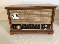 Front view of the Zenith radio showing the wooden cabinet, fabric speaker grille, tuning dial, and control knobs.
