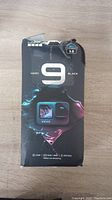 Front of retail box showing GoPro Hero 9 Black branding and key features including Hypersmooth 3.0, 20 MP, 5K30, 4K60, 33 ft waterproof, 1080p live streaming