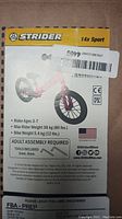 Photo of the Strider 14x Sport packaging showing product details and specifications including rider age range, weight limits, bike weight, assembly requirements.