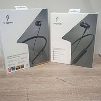 Front view of the 1MORE Dual Driver ANC Pro and 1MORE Piston Fit Bluetooth in-ear headphones factory packaging showing product images and branding.