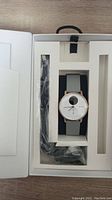Withings Steel HR smartwatch with grey strap in original packaging, includes a black charging cable in the box