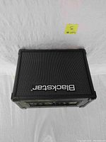 Front view of Blackstar amplifier with metal grille and Blackstar logo.