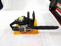 Side view of Poulan Pro 2150 chainsaw on orange cloth showing overall condition and 16 inch guide bar