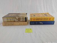 Four books stacked side by side showing spines and covers: The Nez Pierce Indians and the Opening of the Northwest, Complete Book of Hunting, American Indian Myth and Legend, and Indian Herbology of North America.