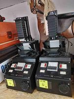 Pair of Bowens Illumitran 3 slide duplicators with cords, showing front and side profile of both units.