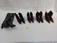 Full view of all 5 pairs of women's shoes arranged on white background showing colors and styles.