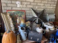 Full view of lot with large pumpkin, rocking horse, metal star, beer tray, enamelware pot, decorative pieces