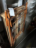 Two stacked wooden drying racks with labels showing lot number and seller notes.