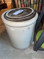 Full view of 6 gallon crock with lid on top showing size and color
