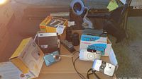 Photo showing Kodak Instamatic Movie camera, Canon SureShot 60 Zoom camera, Bell and Howell 250 camera, Kodak Easy Share digital camera, mini tripod, and camera boxes