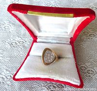 Ring displayed in red velvet presentation box