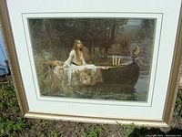 Full view of framed print showing 'The Lady of Shalott' with the woman sitting in the boat on the river.