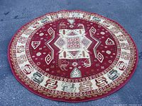 Full view of the red round rug with geometric and tribal patterns.